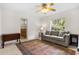 Inviting living room with a comfortable gray sofa and colorful rug, perfect for relaxing and entertaining at 6407 E 112Th Ave, Temple Terrace, FL 33617