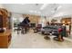 Open-concept living room boasts stone fireplace, grand piano, and abundant natural light at 6407 E 112Th Ave, Temple Terrace, FL 33617