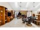 Spacious living room features a fireplace with stone surround and a grand piano at 6407 E 112Th Ave, Temple Terrace, FL 33617