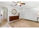 Spacious main bedroom with tile floors, ceiling fan, dresser, and double-door closet at 6407 E 112Th Ave, Temple Terrace, FL 33617