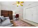 Versatile room featuring a gray sofa, office desk, and a closet providing ample space for various uses at 6407 E 112Th Ave, Temple Terrace, FL 33617