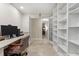 Inviting office with a full wall of built-in bookshelves leading to other rooms at 6407 E 112Th Ave, Temple Terrace, FL 33617