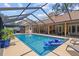 Beautiful pool with lounge chairs and covered patio, perfect for relaxation and entertaining in a private backyard oasis at 6407 E 112Th Ave, Temple Terrace, FL 33617