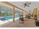 Large pool with screened-in lanai featuring outdoor seating and lush landscaping at 6407 E 112Th Ave, Temple Terrace, FL 33617