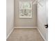Carpeted walk-in closet with wire shelving and a window offering natural light at 6407 E 112Th Ave, Temple Terrace, FL 33617