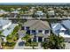 Stunning aerial view of a luxury waterfront home with canal access and a well-manicured lawn at 715 Pinckney Dr, Apollo Beach, FL 33572