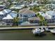 Aerial shot featuring a waterfront home with a screened pool, boat lift, and dock, ideal for boating enthusiasts at 715 Pinckney Dr, Apollo Beach, FL 33572