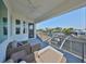 Relaxing covered balcony with waterfront views, comfortable seating, and bright sky at 715 Pinckney Dr, Apollo Beach, FL 33572