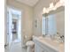 Clean, bright bathroom featuring white fixtures, updated lighting and vanity at 715 Pinckney Dr, Apollo Beach, FL 33572