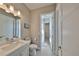 Clean, bright bathroom featuring white fixtures, updated lighting and vanity at 715 Pinckney Dr, Apollo Beach, FL 33572