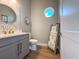 Powder room featuring hexagon tile accent wall and decorative round window at 715 Pinckney Dr, Apollo Beach, FL 33572