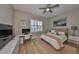 Charming bedroom features a ceiling fan, desk area, and a comfortable bed with stylish decor at 715 Pinckney Dr, Apollo Beach, FL 33572