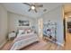 Bright bedroom featuring a plush bed, decorative shelving, and an adjacent bathroom for convenience at 715 Pinckney Dr, Apollo Beach, FL 33572