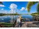 Picturesque view of a wooden dock leading to a calm lake, with colorful kayaks ready for adventure at 715 Pinckney Dr, Apollo Beach, FL 33572