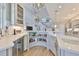 Modern kitchen featuring a bar area with a wine fridge and ample storage, seamlessly flowing into an open floor plan at 715 Pinckney Dr, Apollo Beach, FL 33572