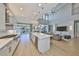 Bright, open kitchen with a spacious island, stainless appliances, and access to the living room at 715 Pinckney Dr, Apollo Beach, FL 33572