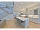Spacious kitchen with a large island, stainless steel appliances, and a staircase leading to the second floor at 715 Pinckney Dr, Apollo Beach, FL 33572