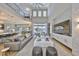 Spacious living room with tall ceilings, a modern entertainment center, and an open connection to the outdoor views at 715 Pinckney Dr, Apollo Beach, FL 33572