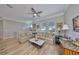 Comfortable living room with patterned sofas, wooden floors, and bright overhead lighting at 715 Pinckney Dr, Apollo Beach, FL 33572