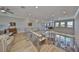 Bright living room with wooden floors and a modern staircase overlooking the well-lit dining area at 715 Pinckney Dr, Apollo Beach, FL 33572
