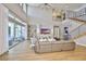 Open living room featuring a large grey sofa, high ceilings, and walls of glass at 715 Pinckney Dr, Apollo Beach, FL 33572