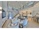 Open-concept living room showcasing a seamless flow between the kitchen, living area, and modern staircase at 715 Pinckney Dr, Apollo Beach, FL 33572