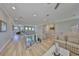 Spacious living room with wooden floors and a modern staircase overlooking the well-lit dining area at 715 Pinckney Dr, Apollo Beach, FL 33572