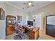 Cozy home office featuring a classic wooden desk, ample shelving, and a comfortable leather chair at 715 Pinckney Dr, Apollo Beach, FL 33572