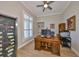 Spacious home office with a large desk, wine refrigerator, and natural light, perfect for remote work at 715 Pinckney Dr, Apollo Beach, FL 33572