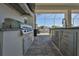 Outdoor grill with stainless steel appliances and ample storage in the outdoor kitchen overlooking the serene waterway at 715 Pinckney Dr, Apollo Beach, FL 33572