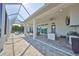 Expansive outdoor living area with a built-in kitchen and a stunning pool view, ideal for entertaining at 715 Pinckney Dr, Apollo Beach, FL 33572