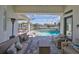 Relaxing covered patio overlooking a sparkling pool and waterfront homes, perfect for outdoor living at 715 Pinckney Dr, Apollo Beach, FL 33572