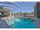 Inviting screened-in pool with in-pool seating, waterfall feature, and tranquil canal views, perfect for relaxing at 715 Pinckney Dr, Apollo Beach, FL 33572
