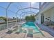 Stunning pool with waterfront views, screened enclosure, and cozy lounge chairs for relaxation at 715 Pinckney Dr, Apollo Beach, FL 33572