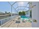 Stunning screened-in pool area with lounge chairs, fire pit, and canal views, perfect for relaxing and entertaining at 715 Pinckney Dr, Apollo Beach, FL 33572