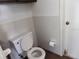 Standard bathroom featuring a toilet, tile wall, and necessary fixtures at 7535 Betula Dr, New Port Richey, FL 34653