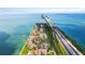 Aerial view of waterfront condos, tennis courts, and the highway running alongside the beautiful shoreline at 7540 Sunshine Skyway S Ln # 219, St Petersburg, FL 33711