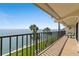 Relax on the tiled balcony with stunning views of the ocean and palm trees, perfect for outdoor dining at 7540 Sunshine Skyway S Ln # 219, St Petersburg, FL 33711