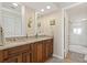 Clean bathroom with granite countertop double vanity, linen closet, and updated shower at 7540 Sunshine Skyway S Ln # 219, St Petersburg, FL 33711