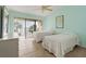 Bright bedroom with twin beds, tile flooring, and balcony access offering scenic views at 7540 Sunshine Skyway S Ln # 219, St Petersburg, FL 33711