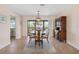 Cozy dining area with a wooden table and chairs, complemented by natural light from the sliding glass doors at 7540 Sunshine Skyway S Ln # 219, St Petersburg, FL 33711