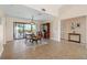 Open dining room with tile floors, chandelier, and sliding glass doors leading to a balcony with water views at 7540 Sunshine Skyway S Ln # 219, St Petersburg, FL 33711