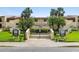 Well-maintained condo complex featuring lush landscaping, palm trees, and clear signage for easy navigation at 7540 Sunshine Skyway S Ln # 219, St Petersburg, FL 33711