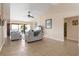 Spacious living room with tile flooring, comfortable sofas, and sliding glass doors leading to a balcony at 7540 Sunshine Skyway S Ln # 219, St Petersburg, FL 33711