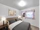 Comfortable bedroom featuring stylish decor, a cozy bed, and natural lighting at 8014 N Lynn Ave, Tampa, FL 33604