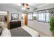 Comfortable bedroom with walk-in closet, vintage ceiling fan, and a view of the en-suite bathroom at 8014 N Lynn Ave, Tampa, FL 33604