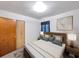 Serene bedroom featuring a comfortable bed, neutral tones, and an adjacent closet for storage at 8014 N Lynn Ave, Tampa, FL 33604