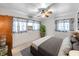 Bright bedroom with a ceiling fan, comfortable bed, and a large window for ample natural light at 8014 N Lynn Ave, Tampa, FL 33604
