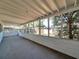 Enclosed outdoor patio with concrete flooring and white-framed windows at 8014 N Lynn Ave, Tampa, FL 33604