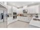 Well-lit kitchen with white cabinetry, stainless steel appliances, and a sleek, modern design at 841 Steel Dr, Apollo Beach, FL 33572